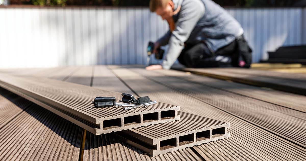 Worker installing wood and plastic composite deck boards